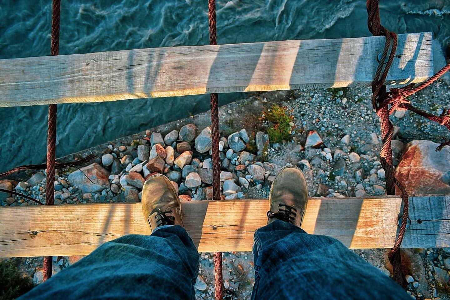Thrill seekers cross the Hussaini  Hanging bridge walking from Passu Village.
