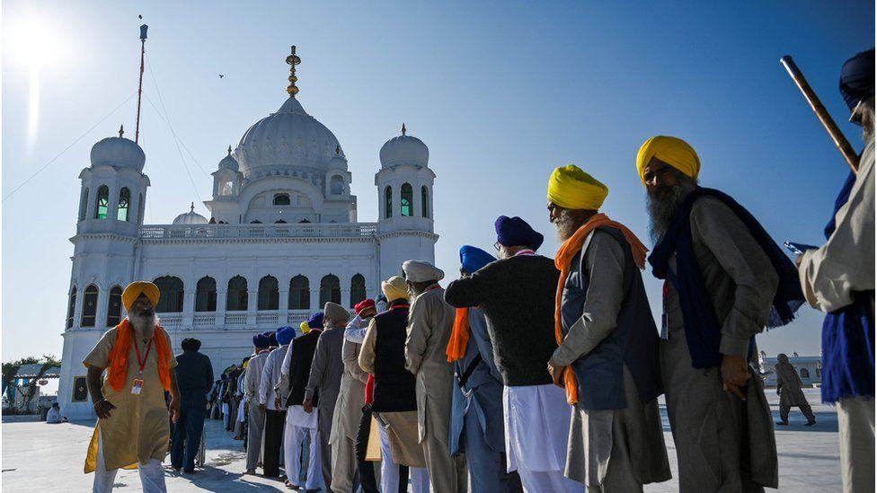 The visitors from India are lined up to visit the Shrine from inside
