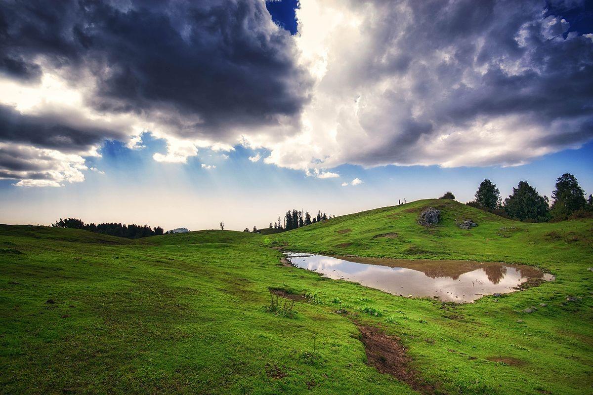 Open grassy summit of Mushkpuri Peak in Khyber Pakhtunkhwa